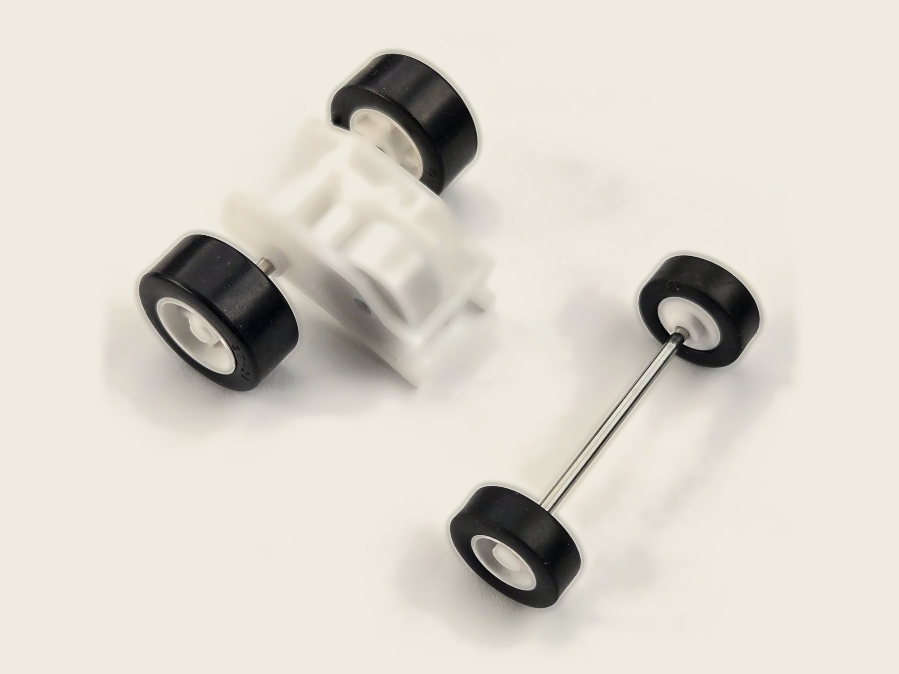 Brute pull-back motor with its matching 16 mm front wheel-and-axle set, its front wheels visibly smaller than the driven rear wheels