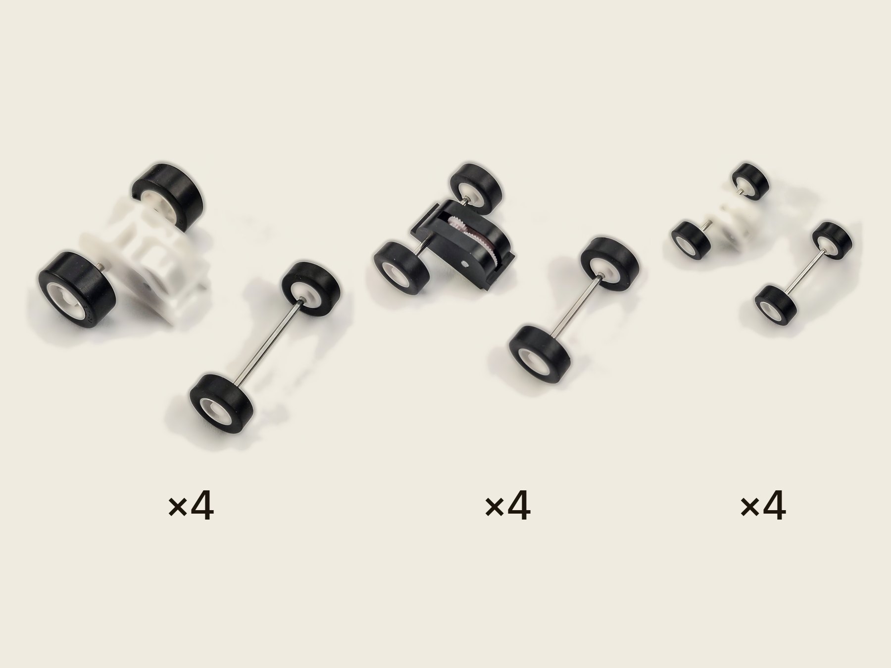 Twelve pull-back motors, four of each size in rows from largest to smallest, with their matching front wheel-and-axle sets